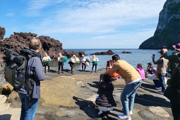 Experience the rich culture of Jeju as local performers showcase traditional dances by the sea surrounded by stunning landscapes that invite exploration and connection with nature.